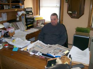 Russell Caswell at the desk in his home office